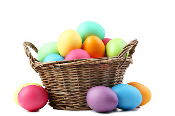 Colorful easter eggs in basket isolated on white background