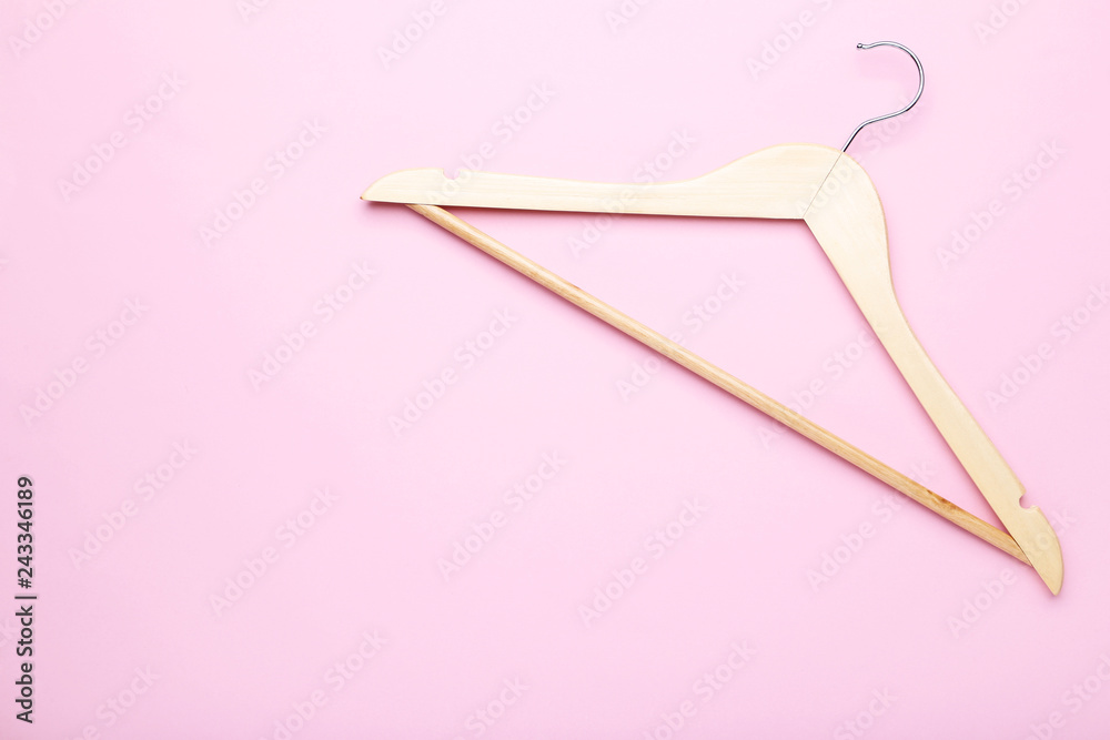 Wooden hanger on pink background Wooden hanger on pink background