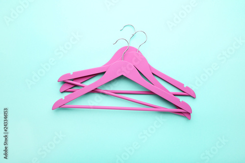 Pink hangers on blue background