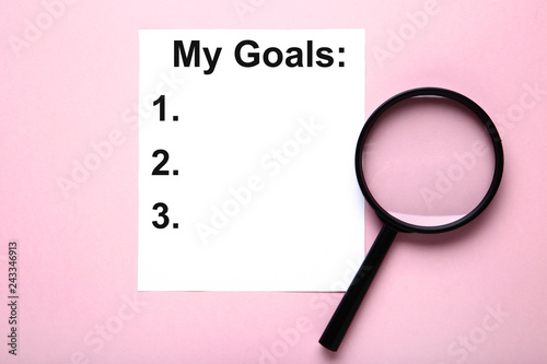 Inscription My goals with magnifying glass on pink background