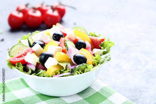 Vegetable salad in bowl on green napkin