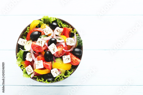 Vegetable salad in bowl on wooden table