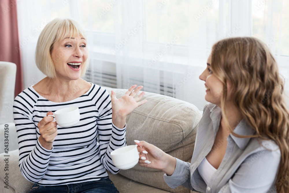 Happy mature mother and daughter drinking coffee and talking Happy mature mother and daughter drinking coffee and talking