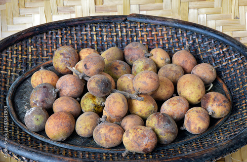 Brazilian fruit: stack of pitomba in the wicker basket