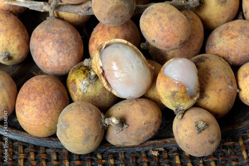 Brazilian fruit: stack of pitomba in the wicker basket photo