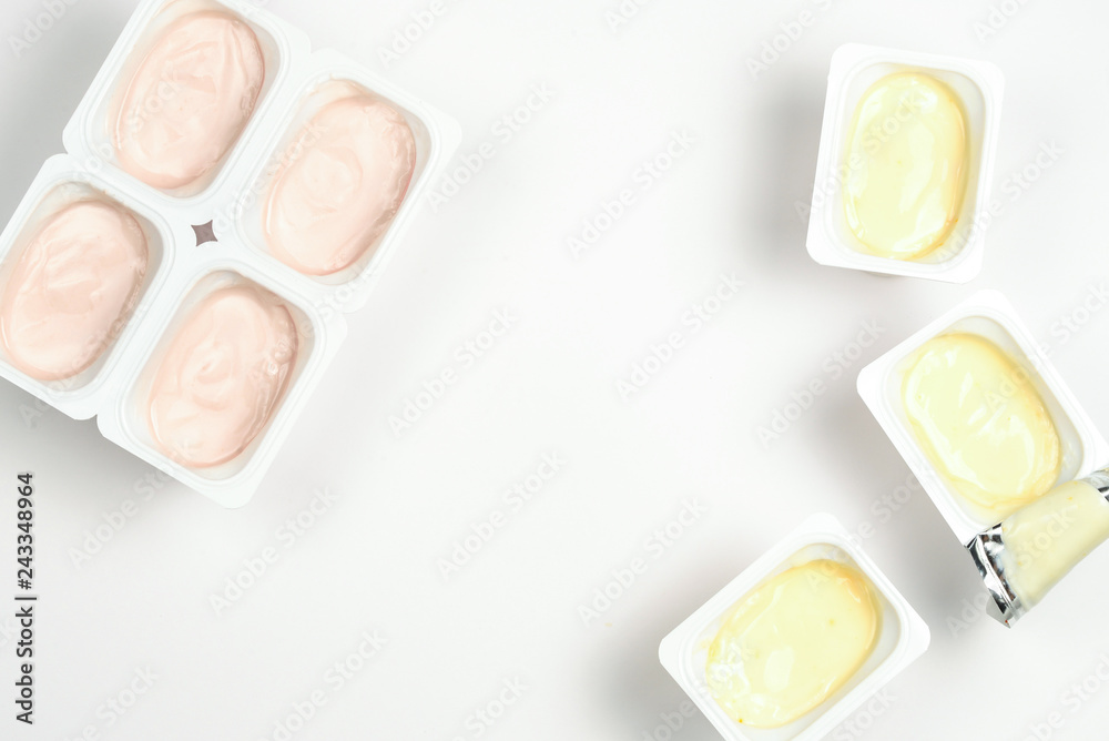 Plastic cup with tasty yogurt isolated on white. Top view. Space for text or design.