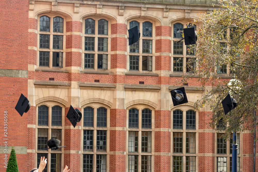 Graduates throwing hats in the air