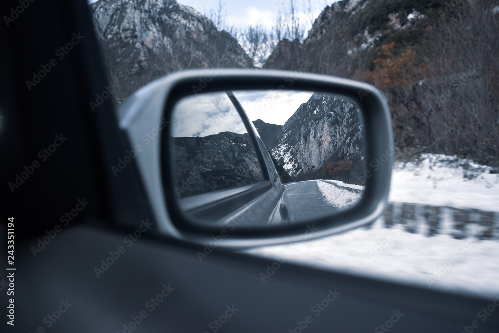 Rearview mirror of a car in a snowed road at winter, south of france Rearview mirror of a car in a snowed road at winter, south of france