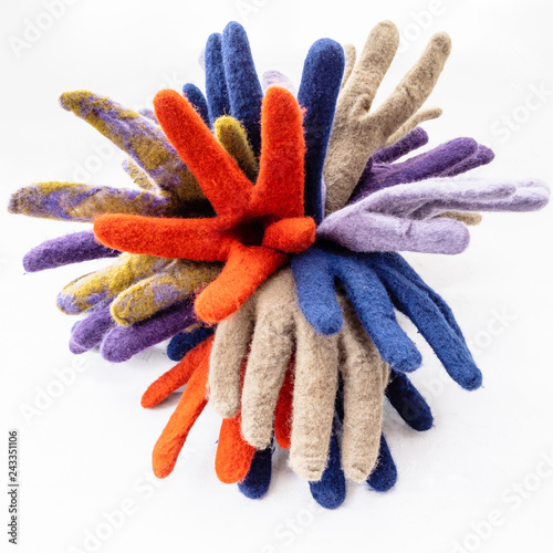 bunch of new multicolored felted gloves on gray
