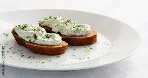 open sandwiches with cheese dill spread decorated with dill