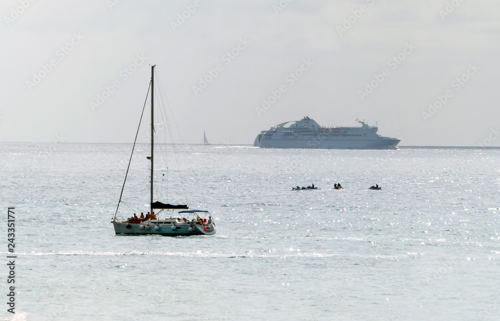 people on a pleasure yacht on the background of the ocean ferry on tenerife people on a pleasure yacht on the background of the ocean ferry on tenerife