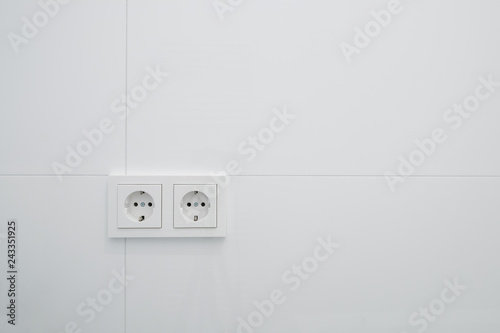 socket   electric plug outlets on white tiles -