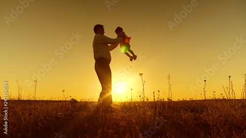 happy dad playing with little daughter, dad circling small child at sunset, Slow motion