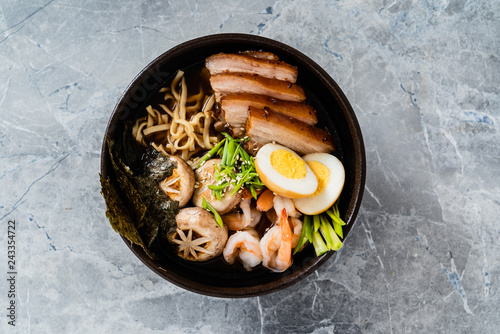 Asian soup with udon, shrimps, egg and roasted pork