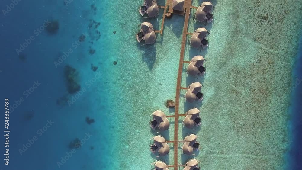 Aerial view of traditional boat departure of a wood dock, Maldives island.