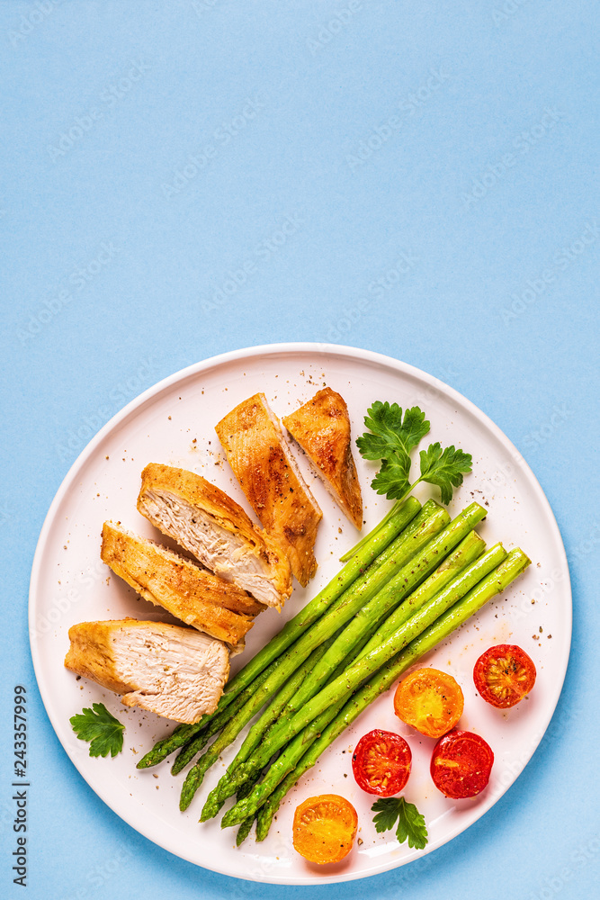 Roasted chicken breast with asparagus and tomatoes. Roasted chicken breast with asparagus and tomatoes.