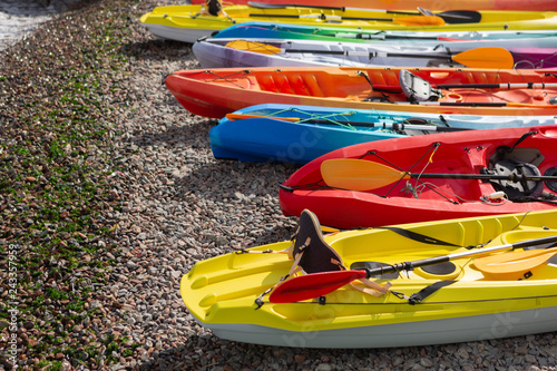 many colored kayaks on the beach, summer