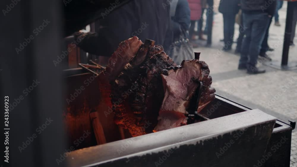 meat skewer roasted on fire, big piece of pork traditional czech prague christmas food meat skewer roasted on fire, big piece of pork traditional czech prague christmas food
