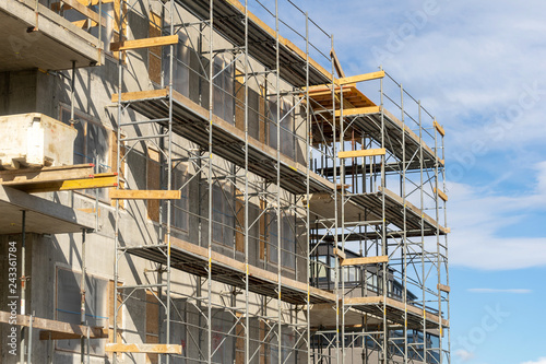 Photo of multistory high rise building with scaffolding photo