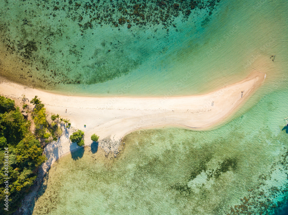 Aerial top view of tropical  beach on island Ditaytayan. Beautiful tropical island with white sandy beach, palm trees and green hills. Travel tropical concept. Palawan, Philippines