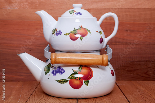 Tableau sur toile Kettle  over wooden background.
