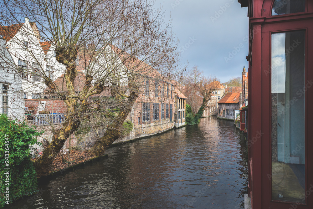 BRUGES, BELGIUM – January 3, 2019: Canals, roofs and facades of the city which was proclaimed as a historical heritage