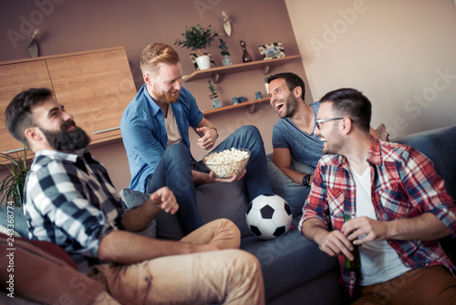 Happy male friends drinking beer at home © ivanko80