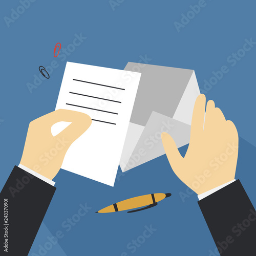 Hand holding letter and put it in envelope