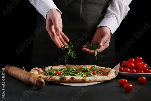 chef make vegetarian pizza with cherry tomatoes and arugula