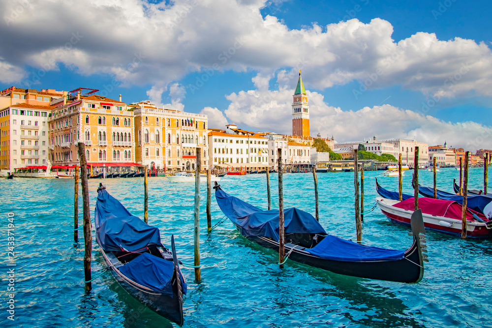 Beautiful view of traditional Gondola on Canal Grande with St Mark's Campanile, San Marco, Venice, Italy.