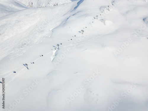 Aerial view of ski chairlift on snow covered mountain in Switzerland