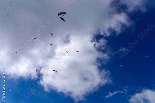 Flying on a parachute in the blue sky