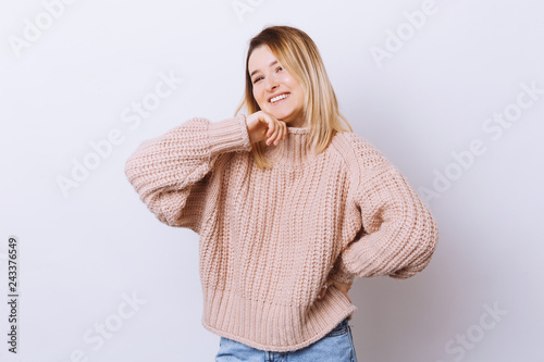 Portrait of pretty girl looking at camera standing over white background