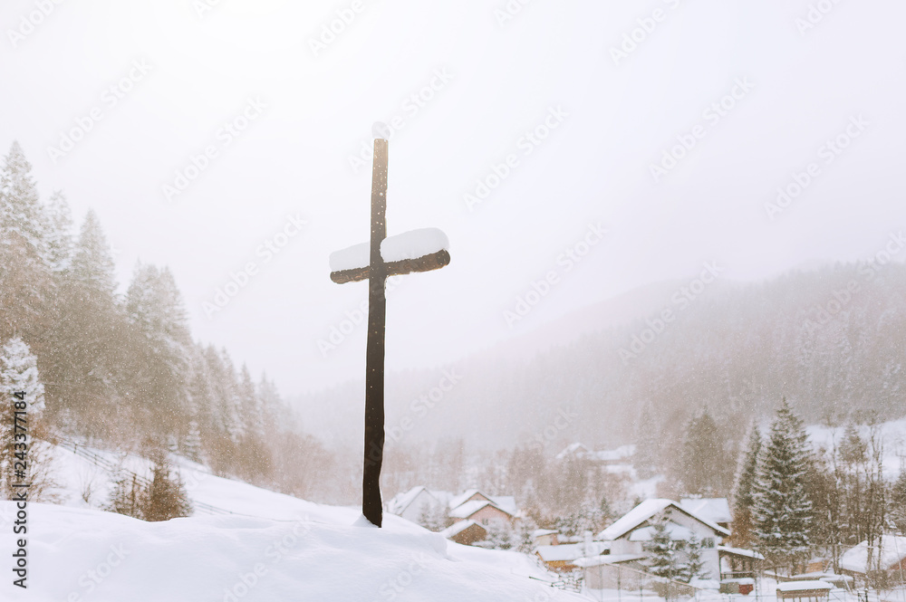Picture of a cross in the hill of the village in winter sason Picture of a cross in the hill of the village in winter sason