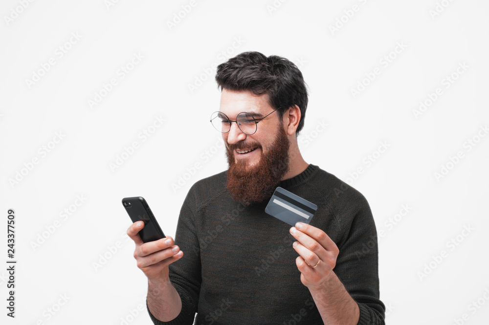 Bearded handsome hipster is happy to shopping oline Bearded handsome hipster is happy to shopping oline