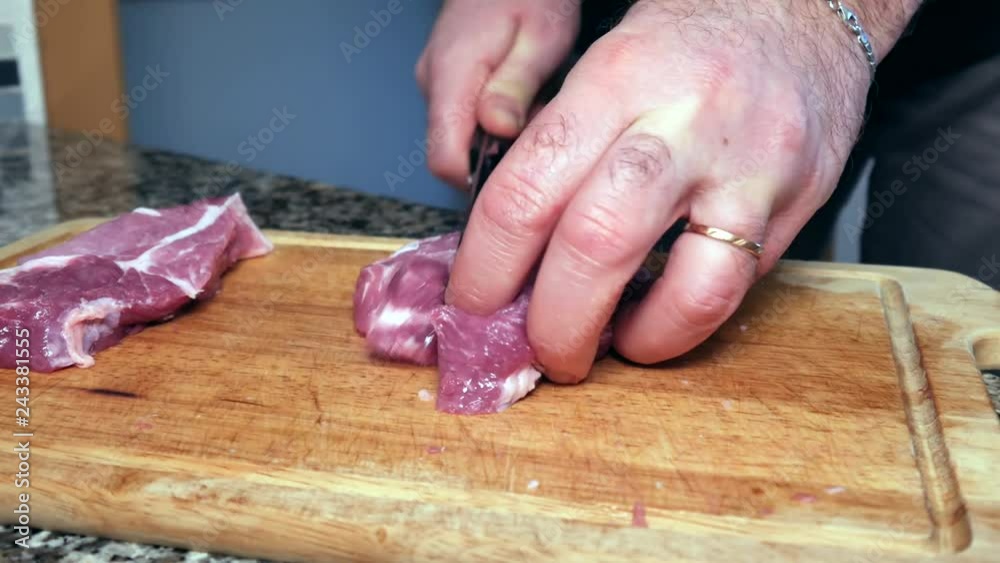 A man cuts the pork A man cuts the pork