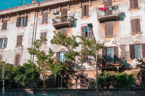Fototapeta Naklejka Na Ścianę i Meble -  colorful house with windows and brown shutters in Italy