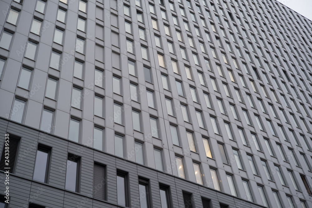 Modern Building - grey facade with lots of windows Modern Building - grey facade with lots of windows