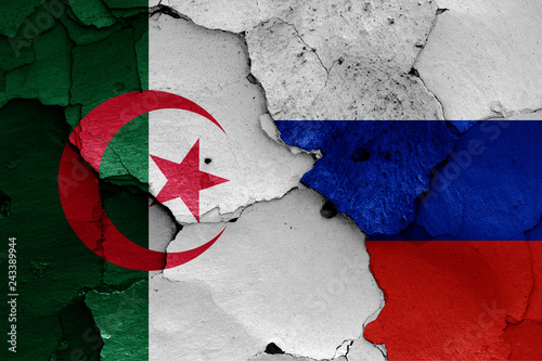 flags of Algeria and Russia painted on cracked wall