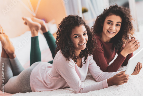 Siblings wearing leggings relaxing at home together photo