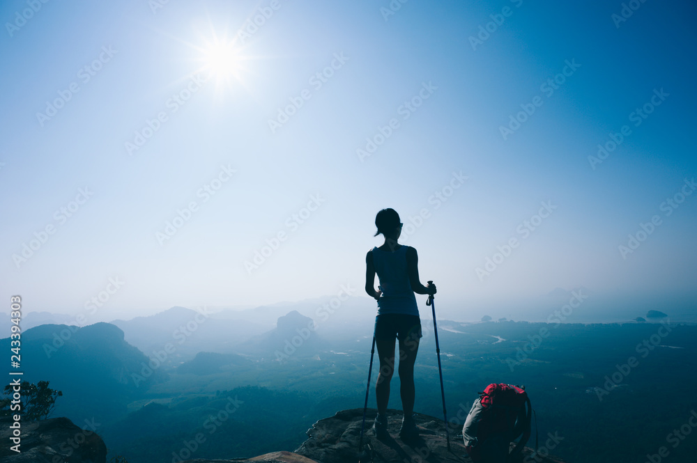 successful hiker hiking on sunset mountain peak successful hiker hiking on sunset mountain peak