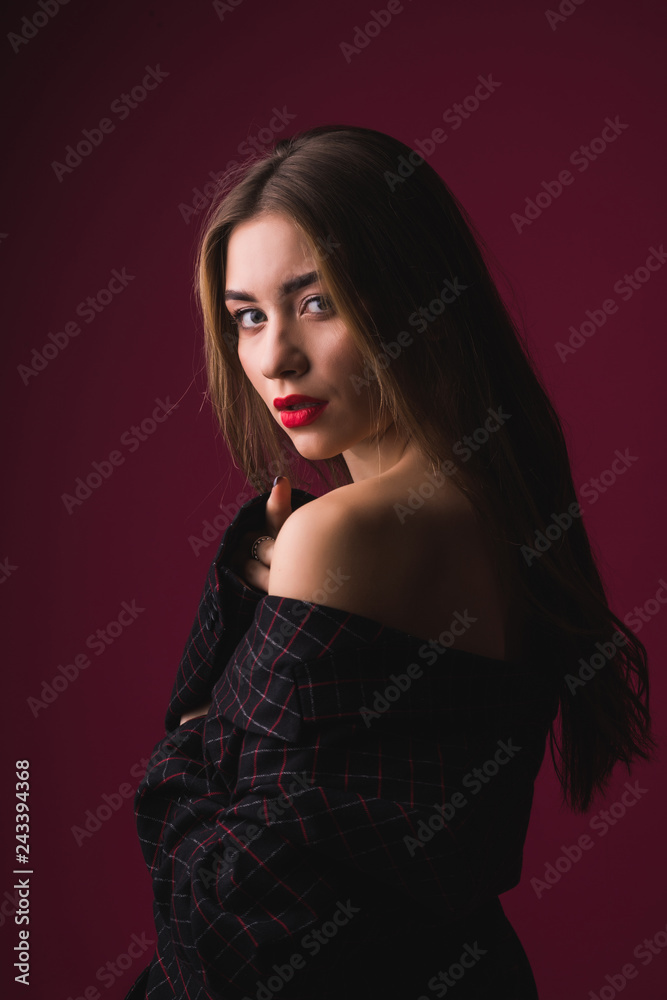 Young woman in fashion outfit with naked shoulder isolated on pink background. Young woman in fashion outfit with naked shoulder isolated on pink background.