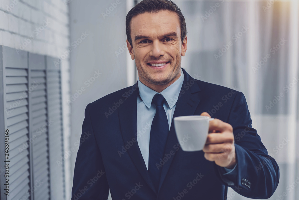 Cheerful attractive man offering you coffee Cheerful attractive man offering you coffee