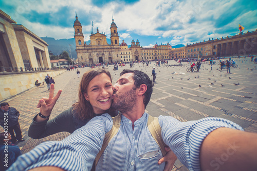 Happy young man taking a selfie photo in Bogota, Colombia. in the main square of the city called Bolivar square photo