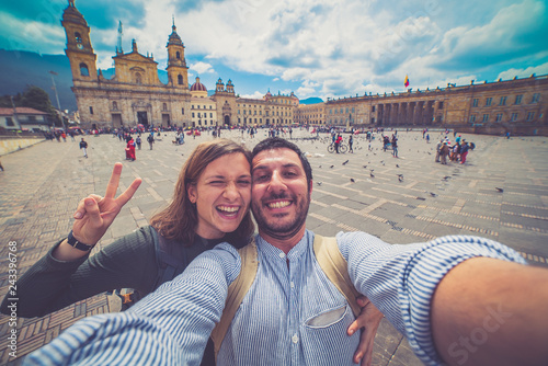 Happy young man taking a selfie photo in Bogota, Colombia. in the main square of the city called Bolivar square photo