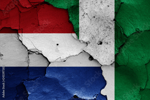 flags of Netherlands and Nigeria painted on cracked wall