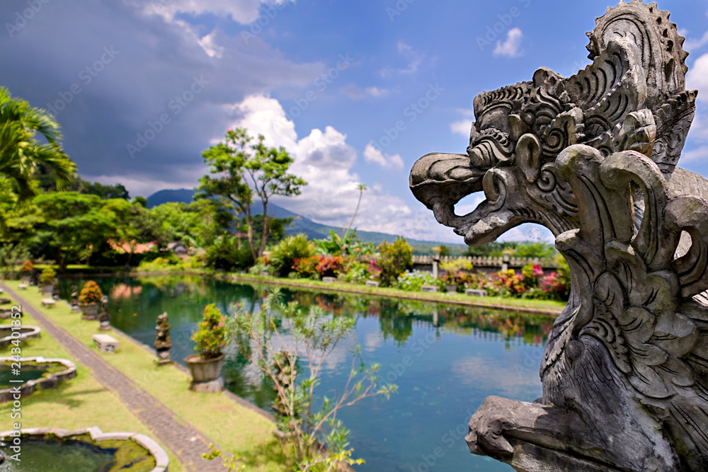 Bali water palace of Tirtagangga with Traditional Balinese stone sculpture/ Indonesia