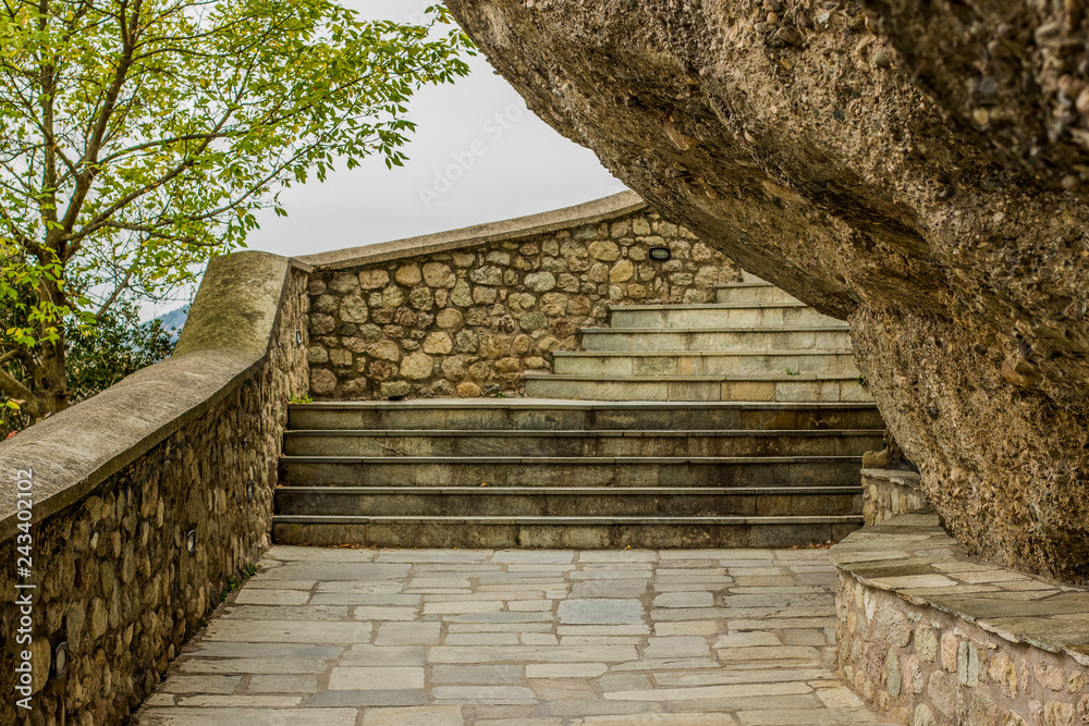 pilgrim stairway path way up to highland monastery around steep rock to top