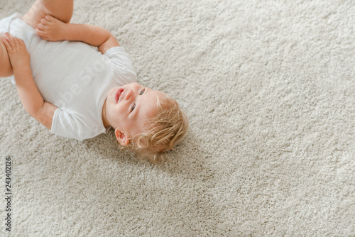 Cute baby lying on the carpet