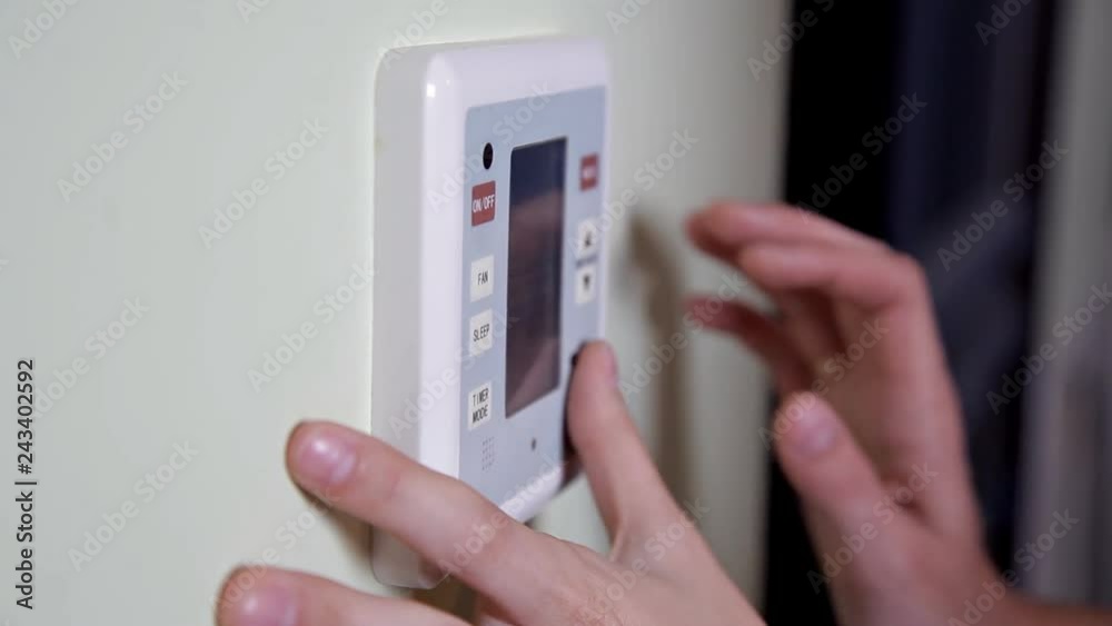 Young woman entering authorization code pin on home alarm keypad. Home security concept Young woman entering authorization code pin on home alarm keypad. Home security concept